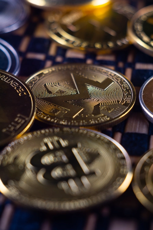 una toma vertical en primer plano de varias monedas de criptomonedas doradas y plateadas